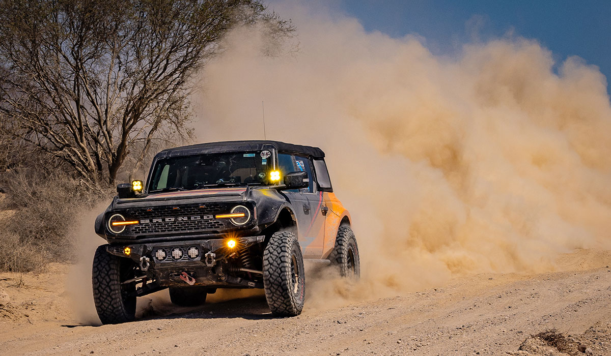 Bronco suspension lift kit from Ride Shocks driving fast off-road through the desert of Mexico.