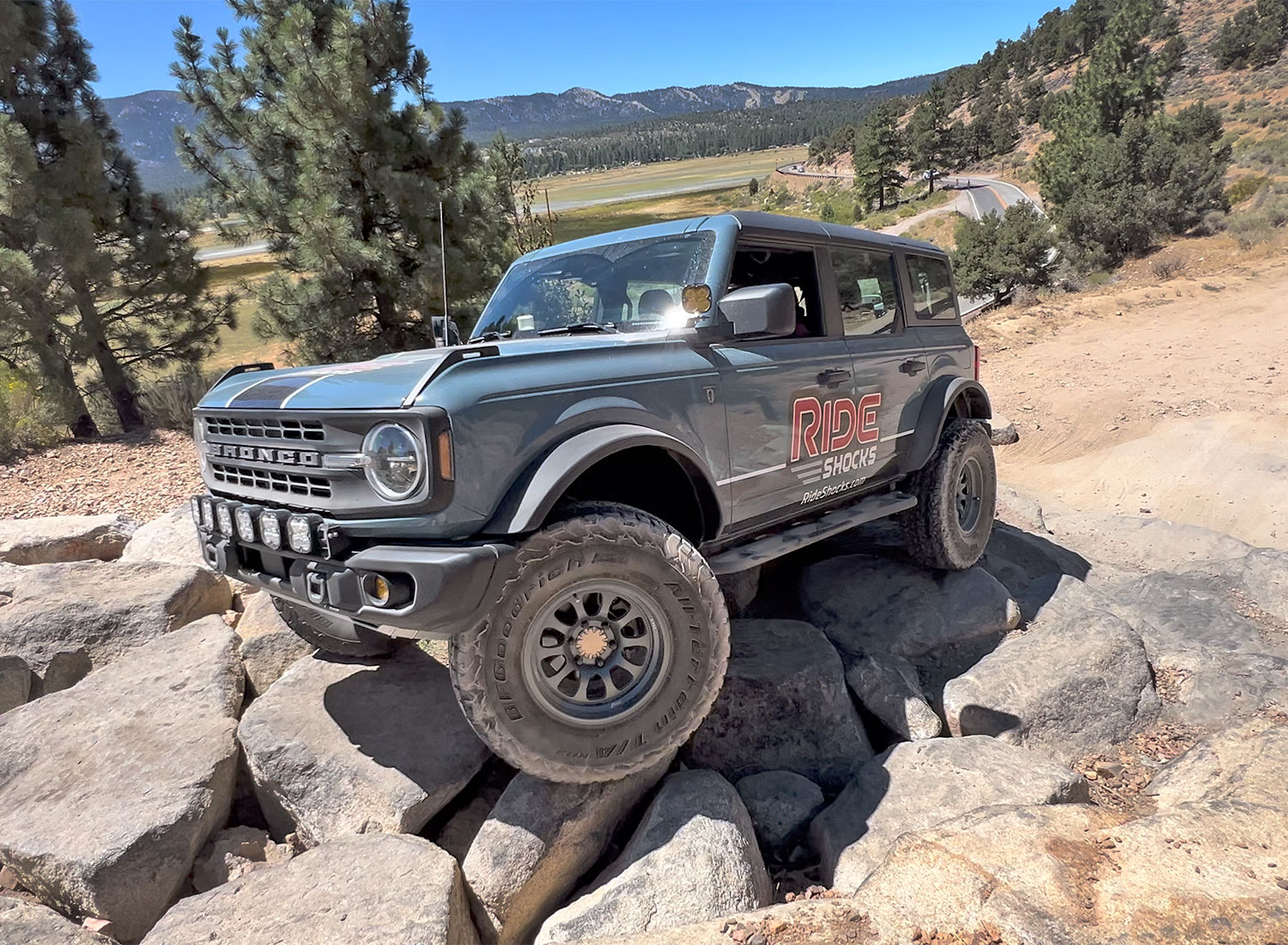 Bronco driving through gatekeeper on Gold Mountain