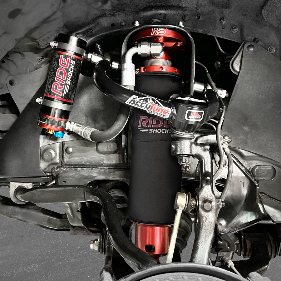Close-up view of Ride Shocks' off-road suspension system installed on a Toyota Tacoma, featuring precision-engineered components for superior performance.