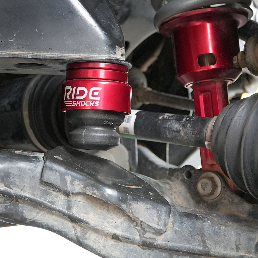 Ride Shocks Tacoma front bump stop installed with red cups.