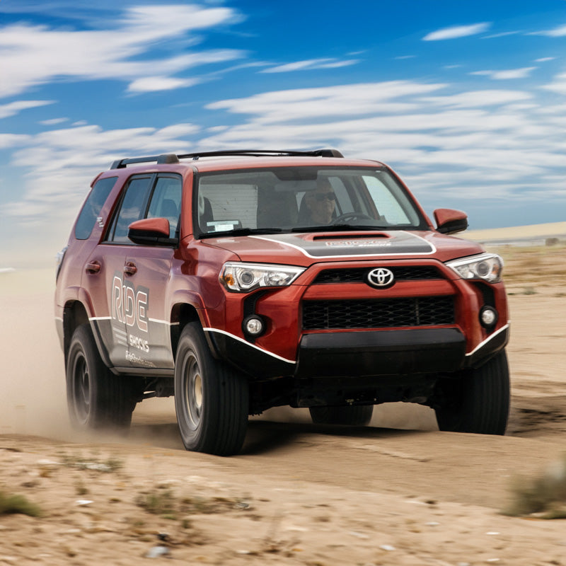 Toyota 4Runner equipped with Ride Shocks driving fast through the desert, soaking up bumps easily.